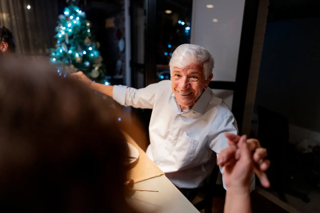 Senior man celebrating with family at Christmas dinner